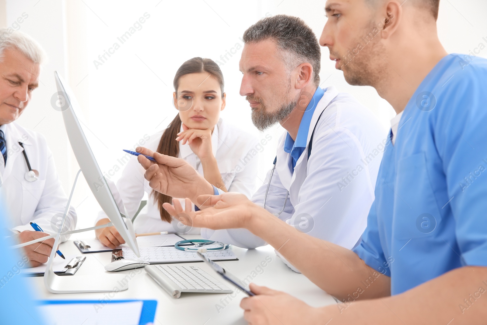 Photo of Group of doctors attending meeting in clinic. Cardiology conference