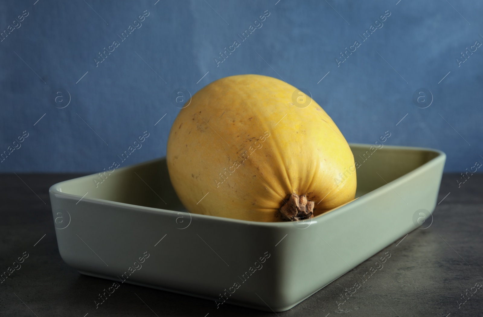 Photo of Baking dish with spaghetti squash on gray table