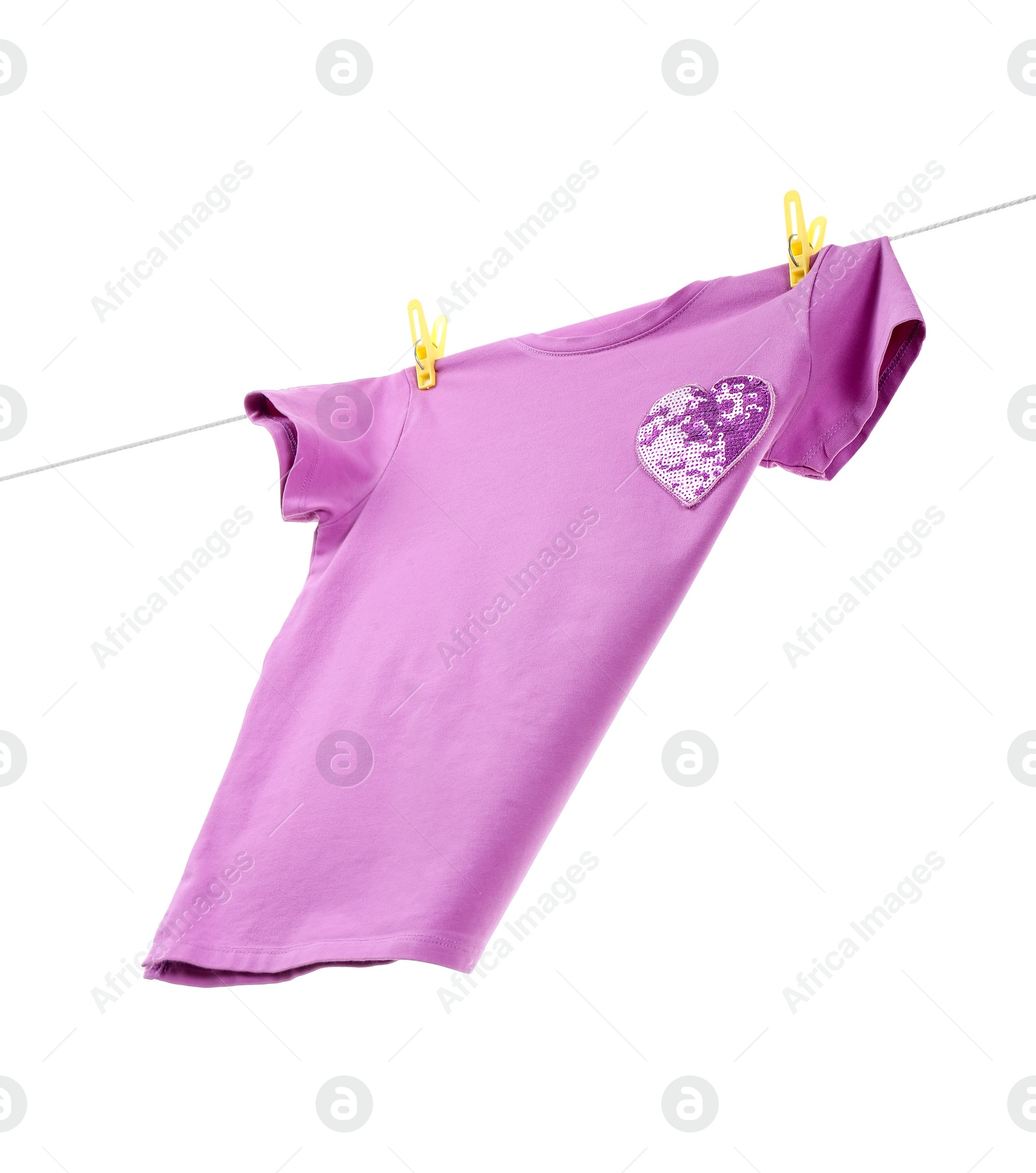 Photo of One violet t-shirt drying on washing line isolated on white