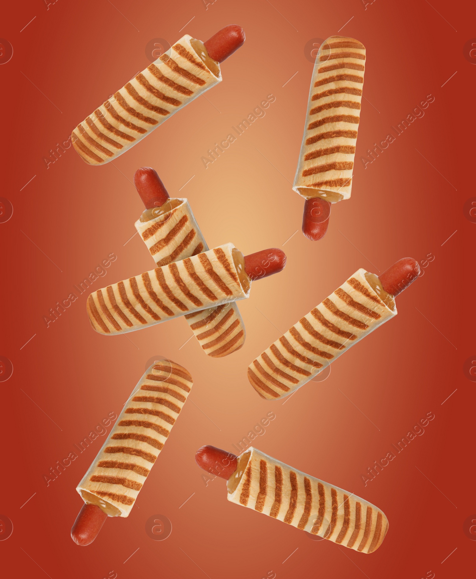 Image of Yummy French hot dogs with grilled buns falling on red gradient background