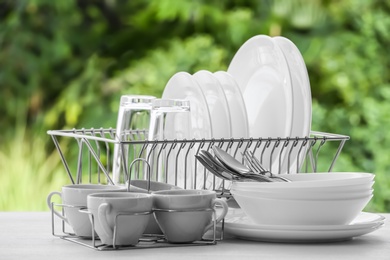 Photo of Set of clean dishware on table against blurred background