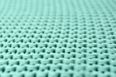 Photo of Knitted mint blue fabric texture as background, closeup