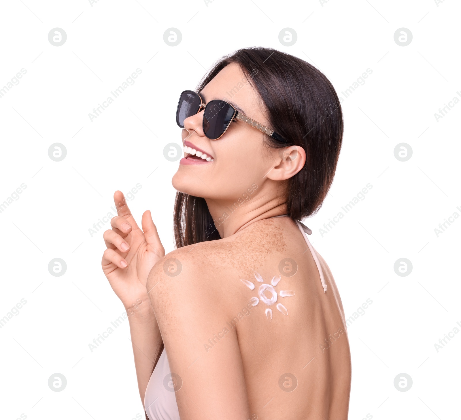 Photo of Beautiful young woman in sunglasses with sun protection cream on her back against white background