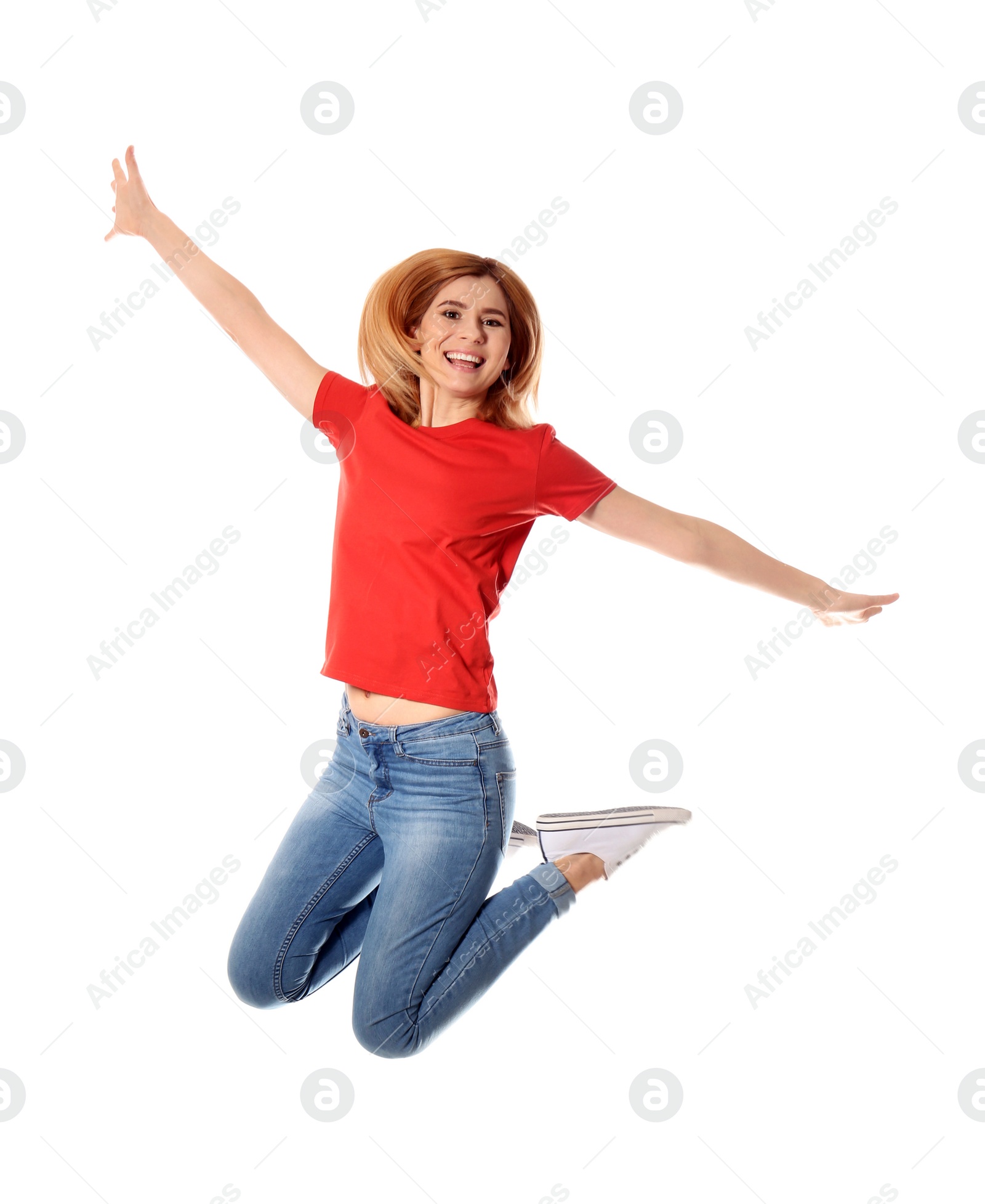 Photo of Full length portrait of happy beautiful woman jumping on white background