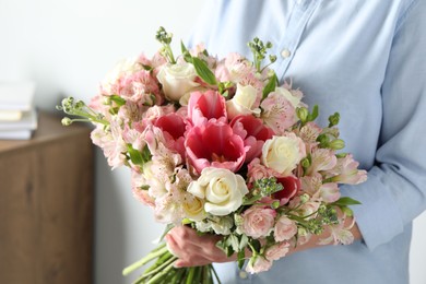 Photo of Woman with beautiful bouquet of fresh flowers indoors, closeup