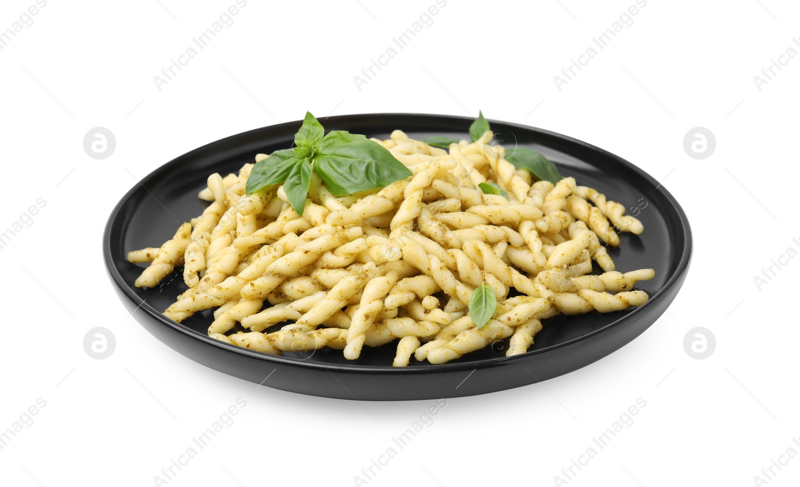 Photo of Plate of delicious trofie pasta with pesto sauce and basil leaves isolated on white