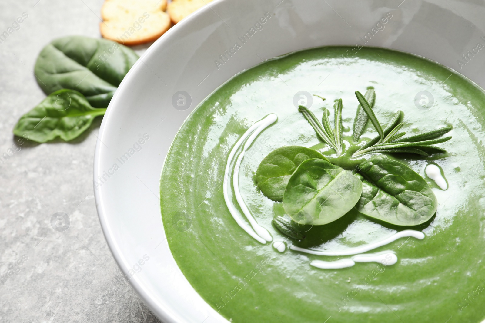 Photo of Fresh vegetable detox soup made of spinach in dish on table, closeup