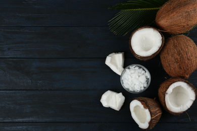 Photo of Flat lay composition with coconut oil on dark wooden table, space for text. Cooking ingredients