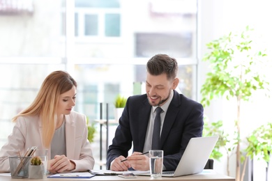 Young consultant working with client in office