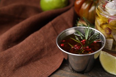 Photo of Tasty fish marinade with rosemary in bowl on wooden table, closeup