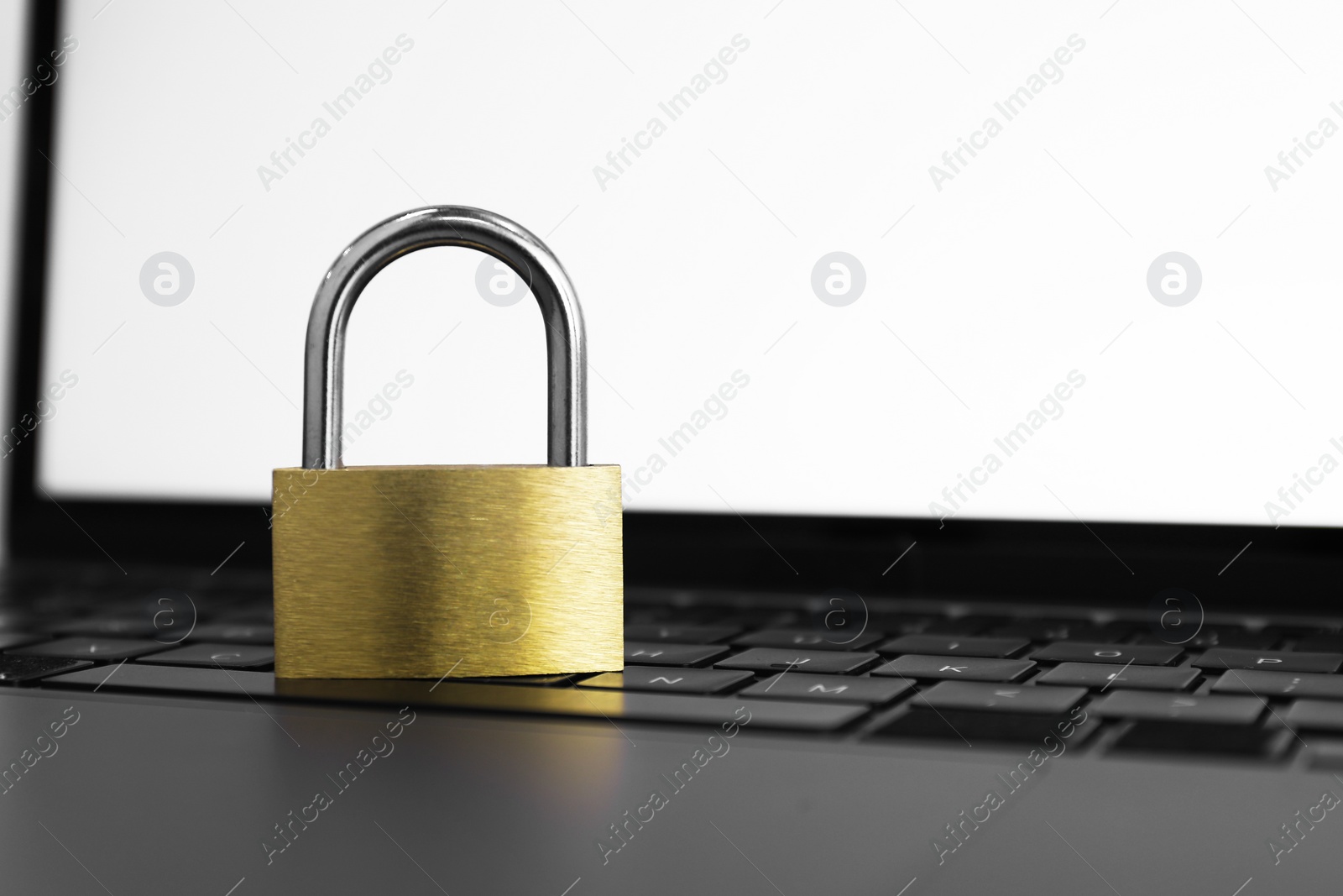 Photo of Cyber security. Metal padlock on laptop, closeup. Space for text