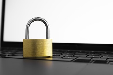 Cyber security. Metal padlock on laptop, closeup. Space for text