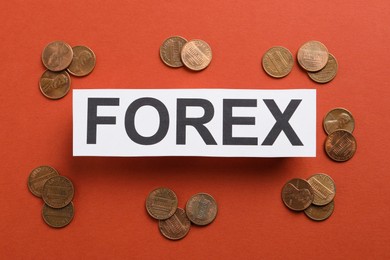 Photo of Sheet of paper with word Forex and coins on red background, flat lay