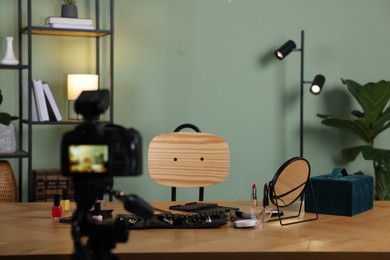 Beauty blogger's workplace. Cosmetic products on table indoors