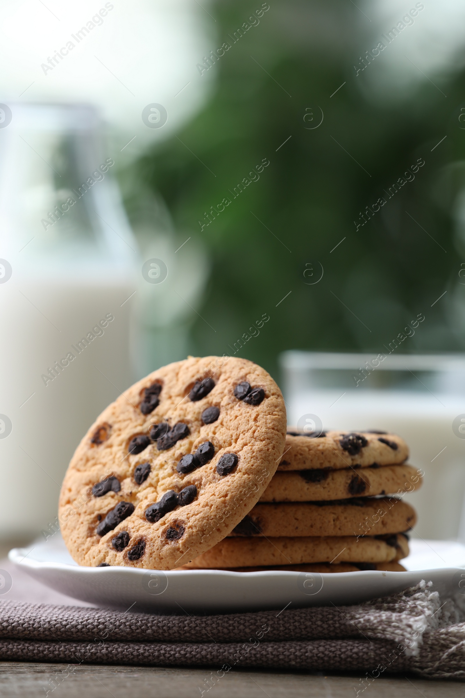 Photo of Delicious chocolate chip cookies on wooden table, closeup