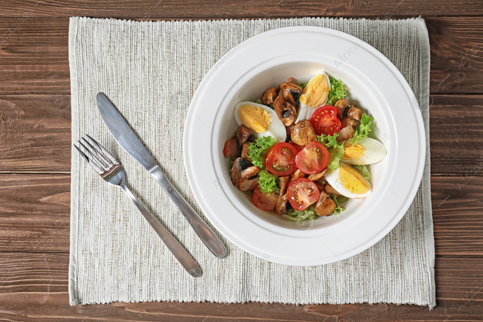 Photo of Plate with delicious fresh salad on table, top view