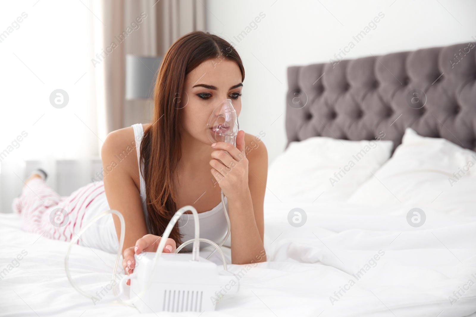 Photo of Woman with asthma machine in light bedroom