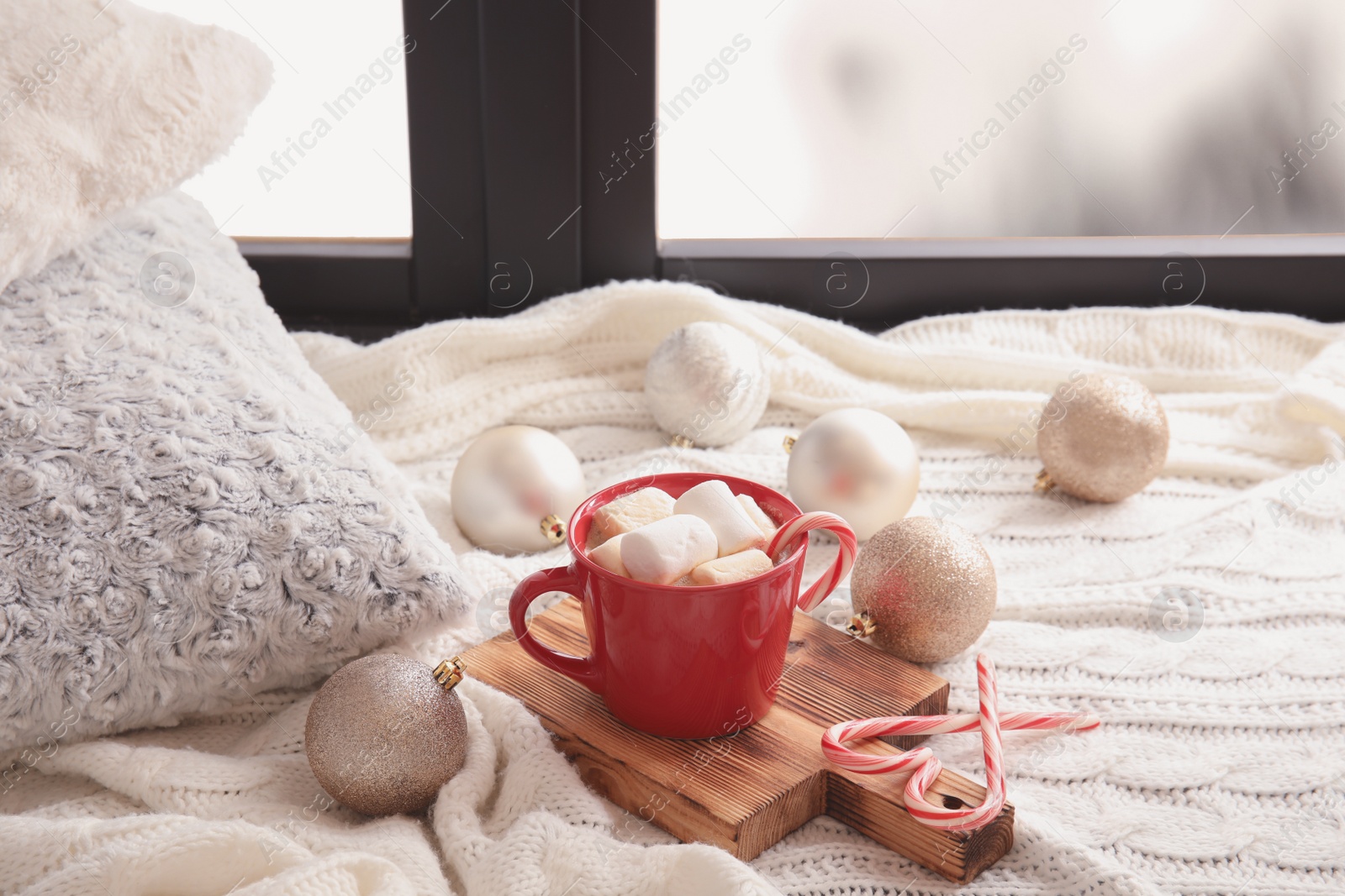 Photo of Composition with cup of hot winter drink near window. Cozy season