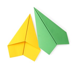 Photo of Handmade green and yellow paper planes isolated on white, top view