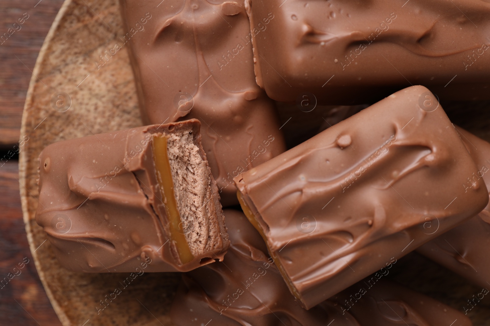 Photo of Tasty chocolate bars with nougat on table, top view