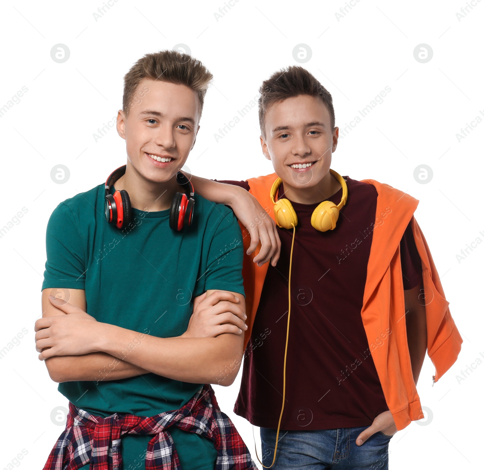 Photo of Teenage twin brothers with headphones on white background