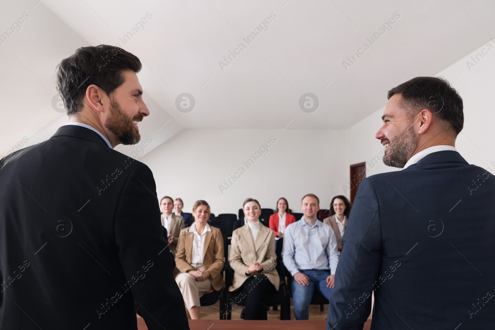 Photo of Business trainers giving lecture in conference room