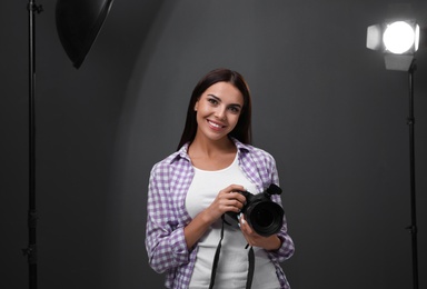 Photo of Professional photographer with modern camera in studio