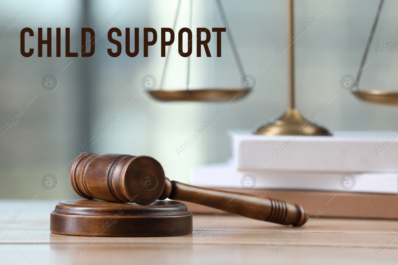 Image of Judge's gavel, scales of justice and book on wooden table. Child support concept