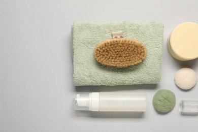 Bath accessories. Flat lay composition with personal care products on light grey background, space for text