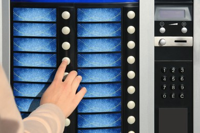 Image of Using coffee vending machine. Woman pressing button to choose drink, closeup
