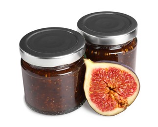 Photo of Glass jars of tasty sweet fig jam isolated on white