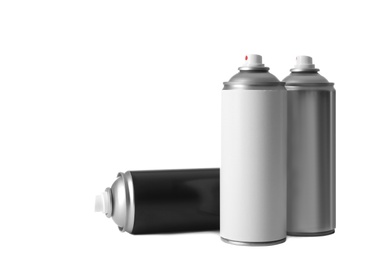 Cans of different spray paints on white background