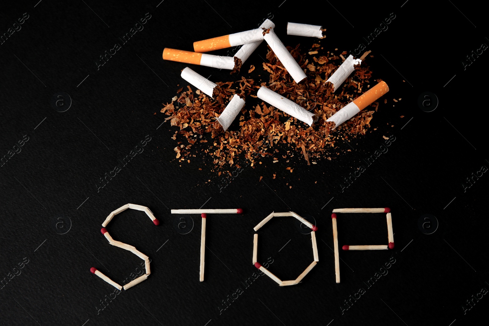Photo of Word Stop made of matches and broken cigarettes on black background, above view. Quitting smoking concept