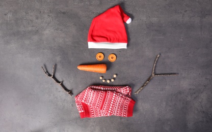 Photo of Funny snowman made with different elements on grey background, flat lay