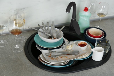 Photo of Pile of dirty dishes in kitchen after party