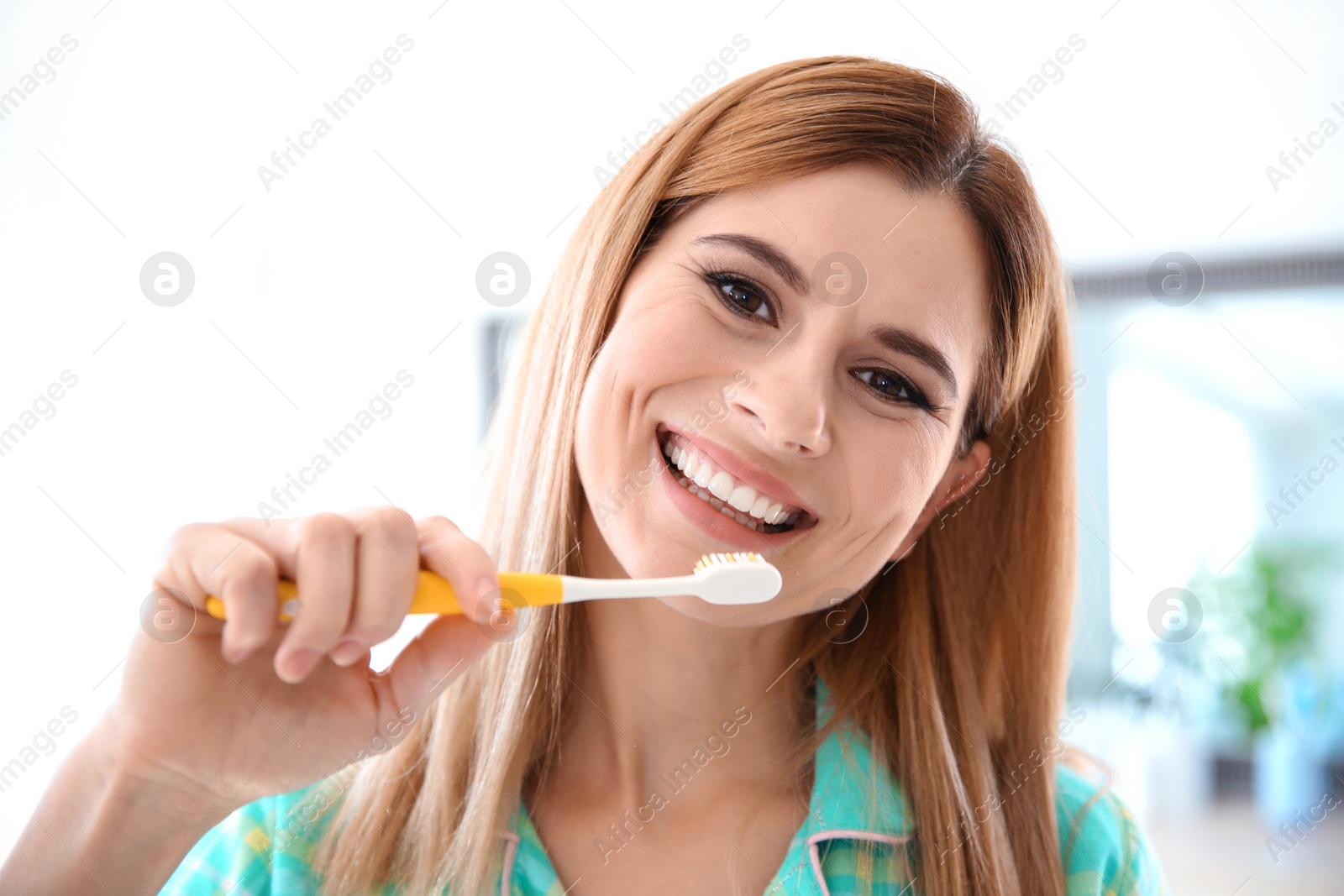 Photo of Portrait of woman with toothbrush in bathroom. Personal hygiene