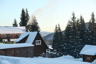 Wooden houses covered with snow. Winter vacation