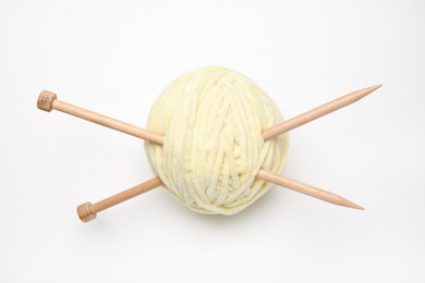 Photo of Soft yarn with knitting needles on white background