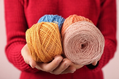 Photo of Woman holding colorful clews of threads, closeup