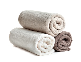 Photo of Rolled soft terry towels on white background