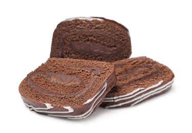 Slices of tasty chocolate cake roll with cream on white background