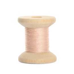 Photo of Wooden spool of pale pink sewing thread isolated on white