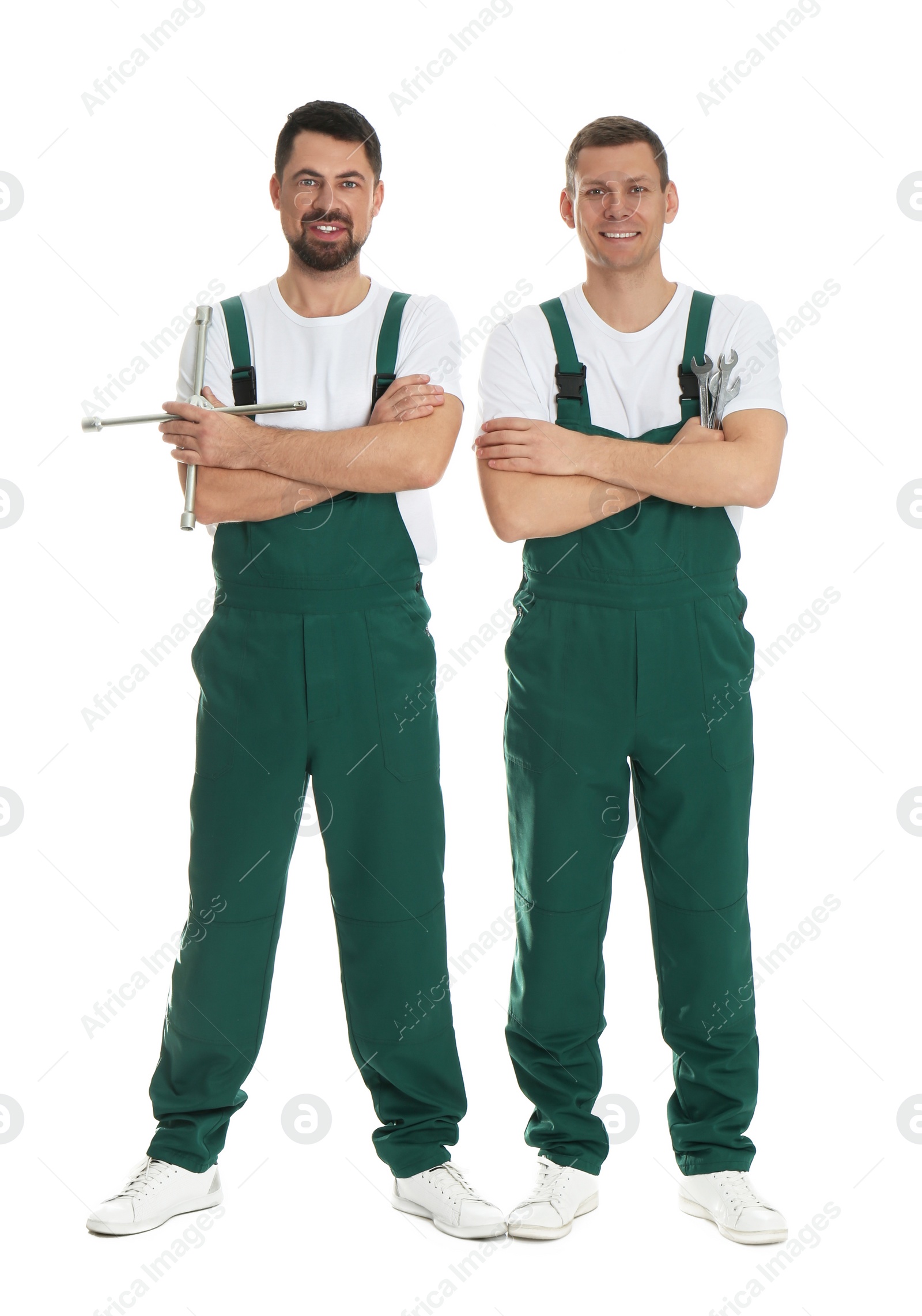 Photo of Full length portrait of professional auto mechanics on white background