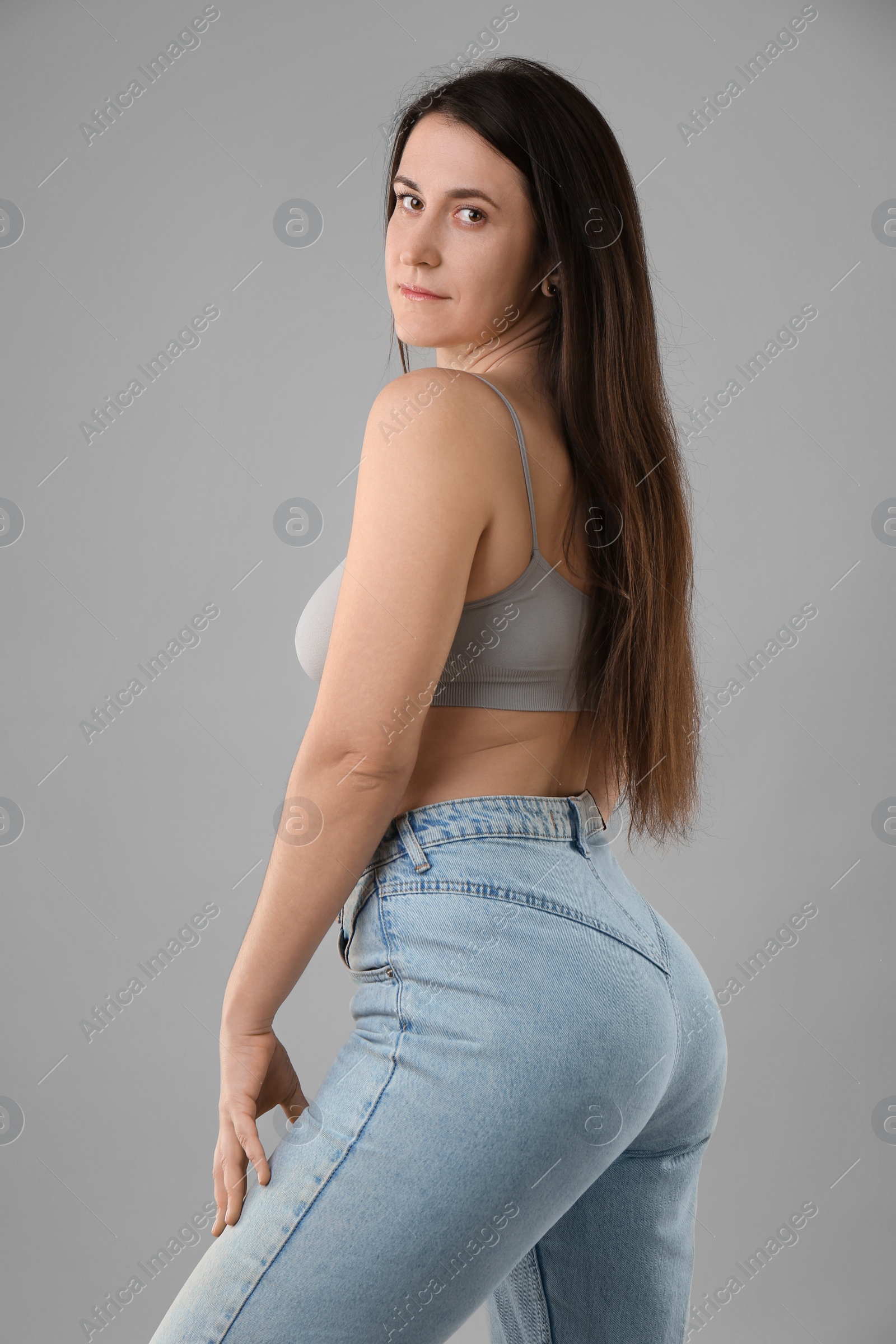 Photo of Portrait of beautiful young woman on light grey background