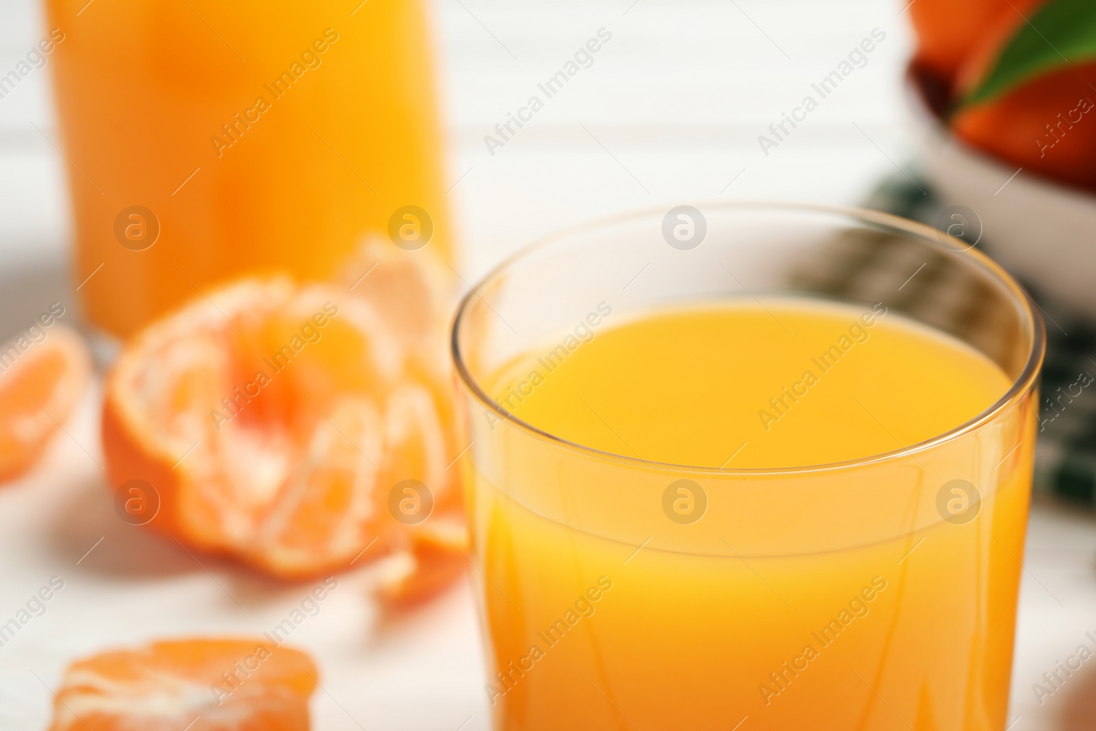 Photo of Glass of fresh tangerine juice, closeup view