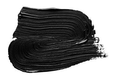 Brushstrokes of black oil paint on white background, top view