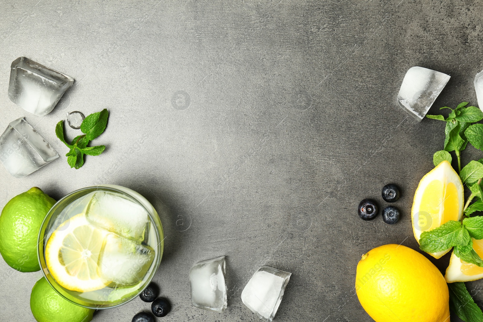 Photo of Flat lay composition with detox lemonade and ingredients on grey background