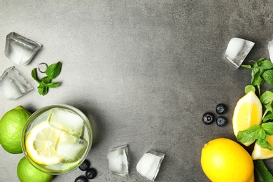 Flat lay composition with detox lemonade and ingredients on grey background