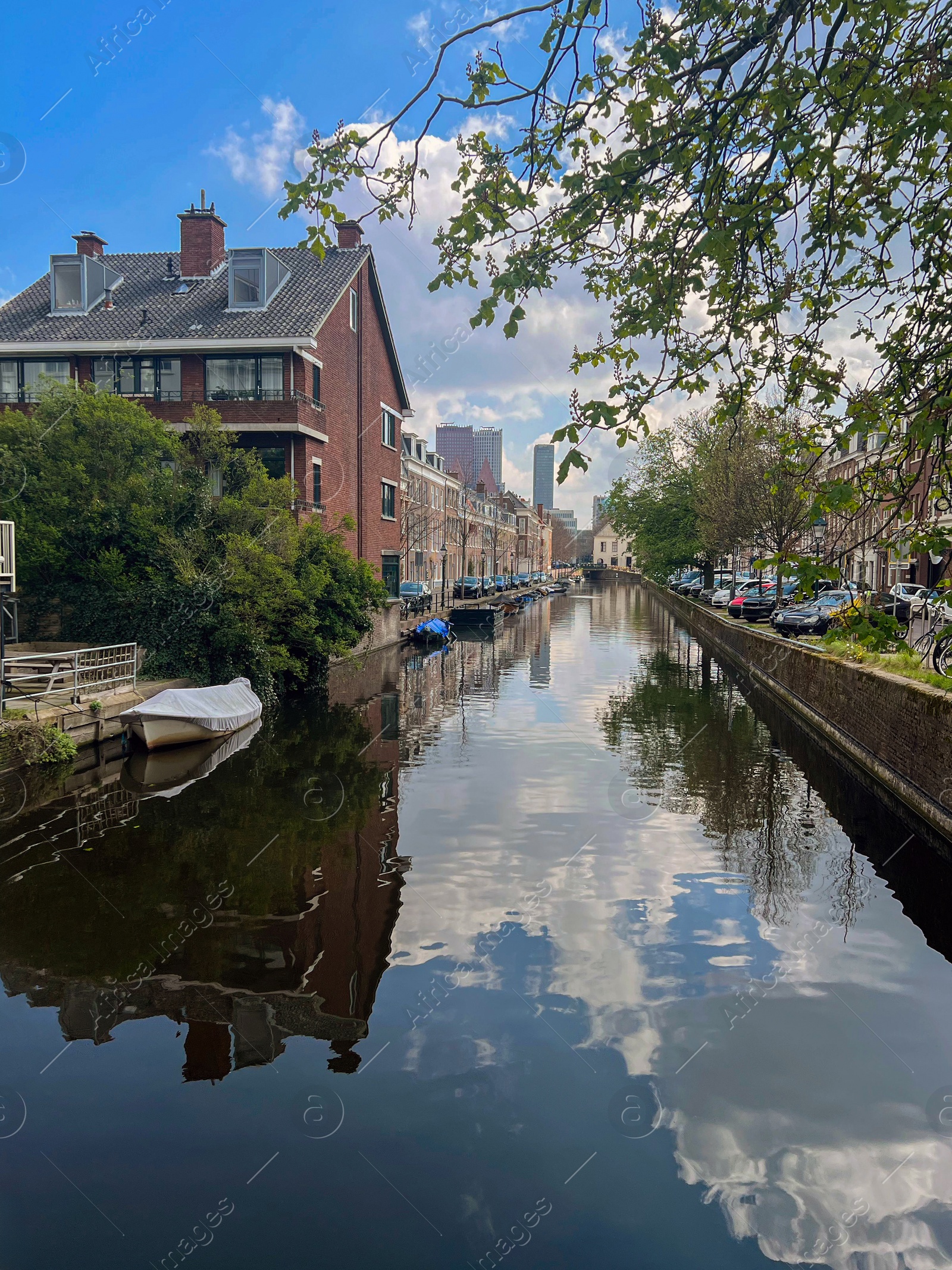 Photo of Beautiful view of buildings near canal with moored boats in city