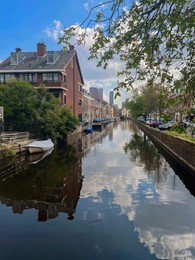 Beautiful view of buildings near canal with moored boats in city